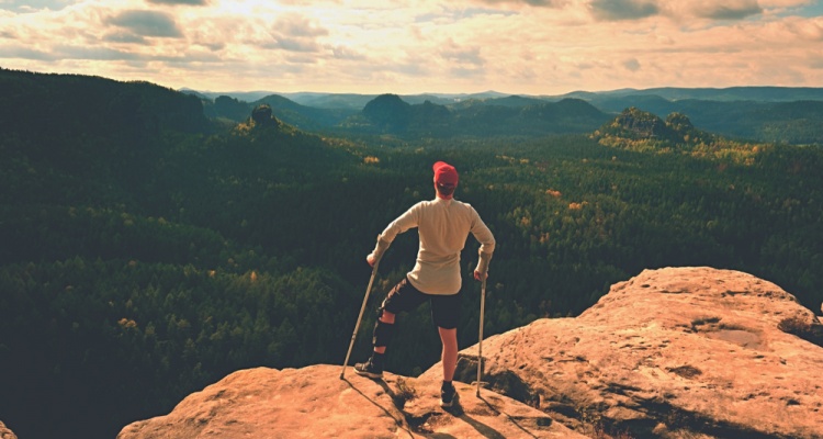 Tired tourist with crutches in hands.