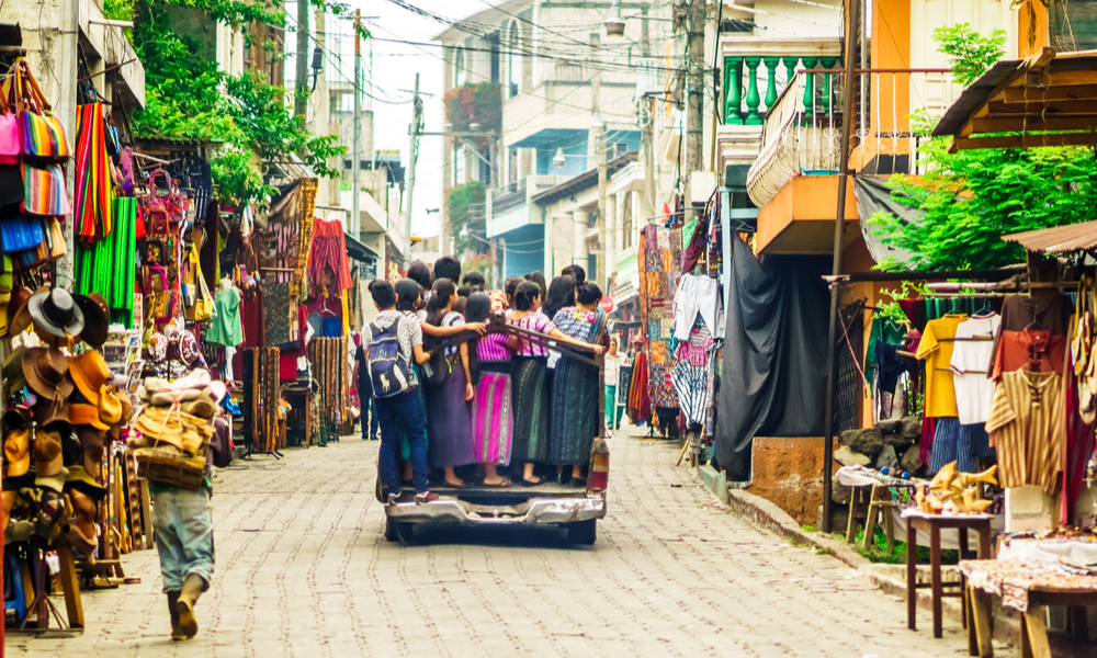 View on Group of indigenous Maya kids using public transpart by small village in Guatemala