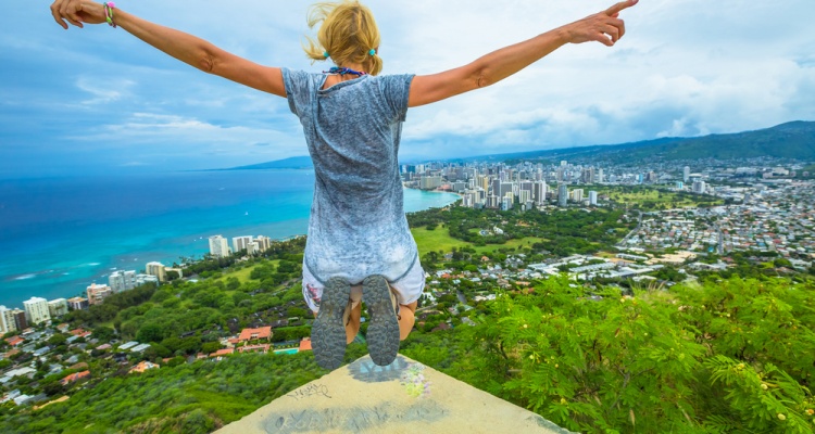 Happy hiker jumping. Hawaiian hiking by popular Diamond Head hike.