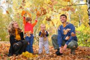 Family playing with leaves