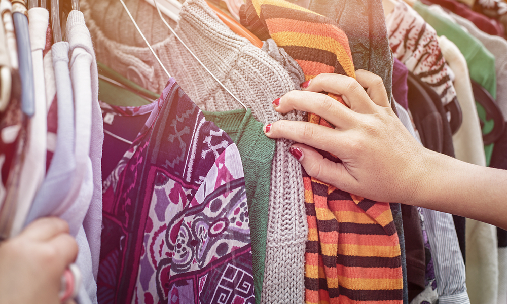 close up of a hand, looking on a flea market for clothes.